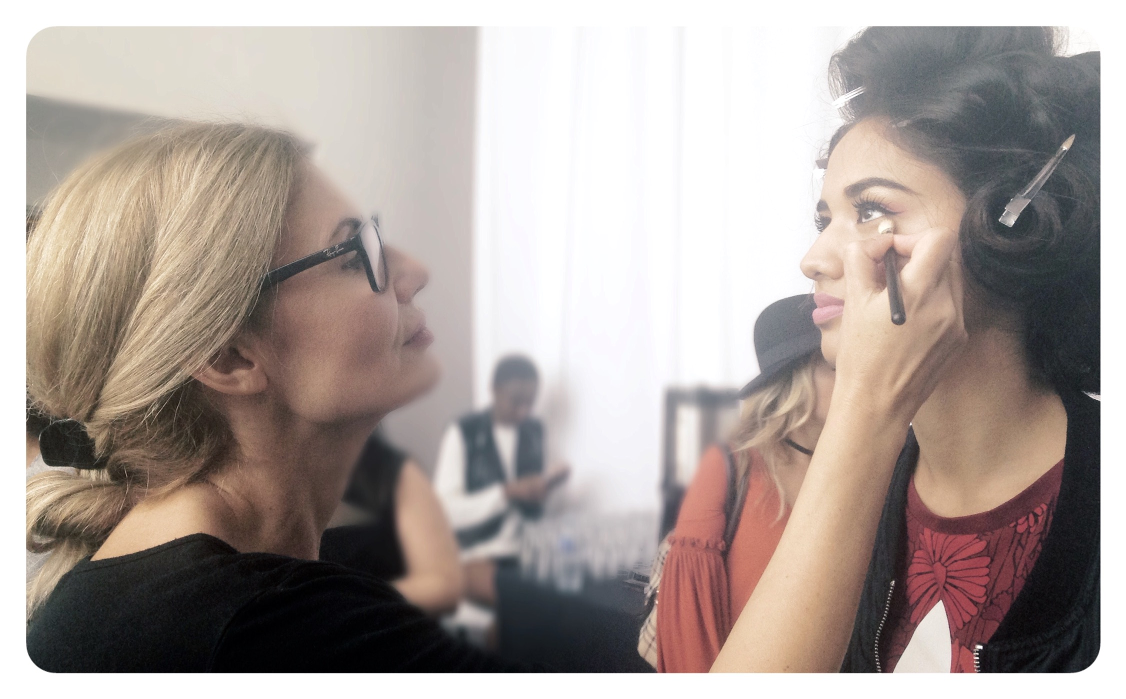 Irene Kyranis, a Bridal make up artist in Greece is applying make up to a beautiful bride