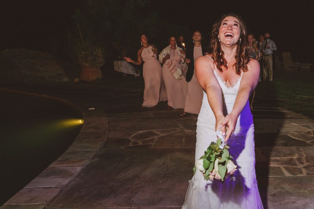 A bride is about to toss her bouquet after her wedding ceremony at villa Delenia in Evia, Greece