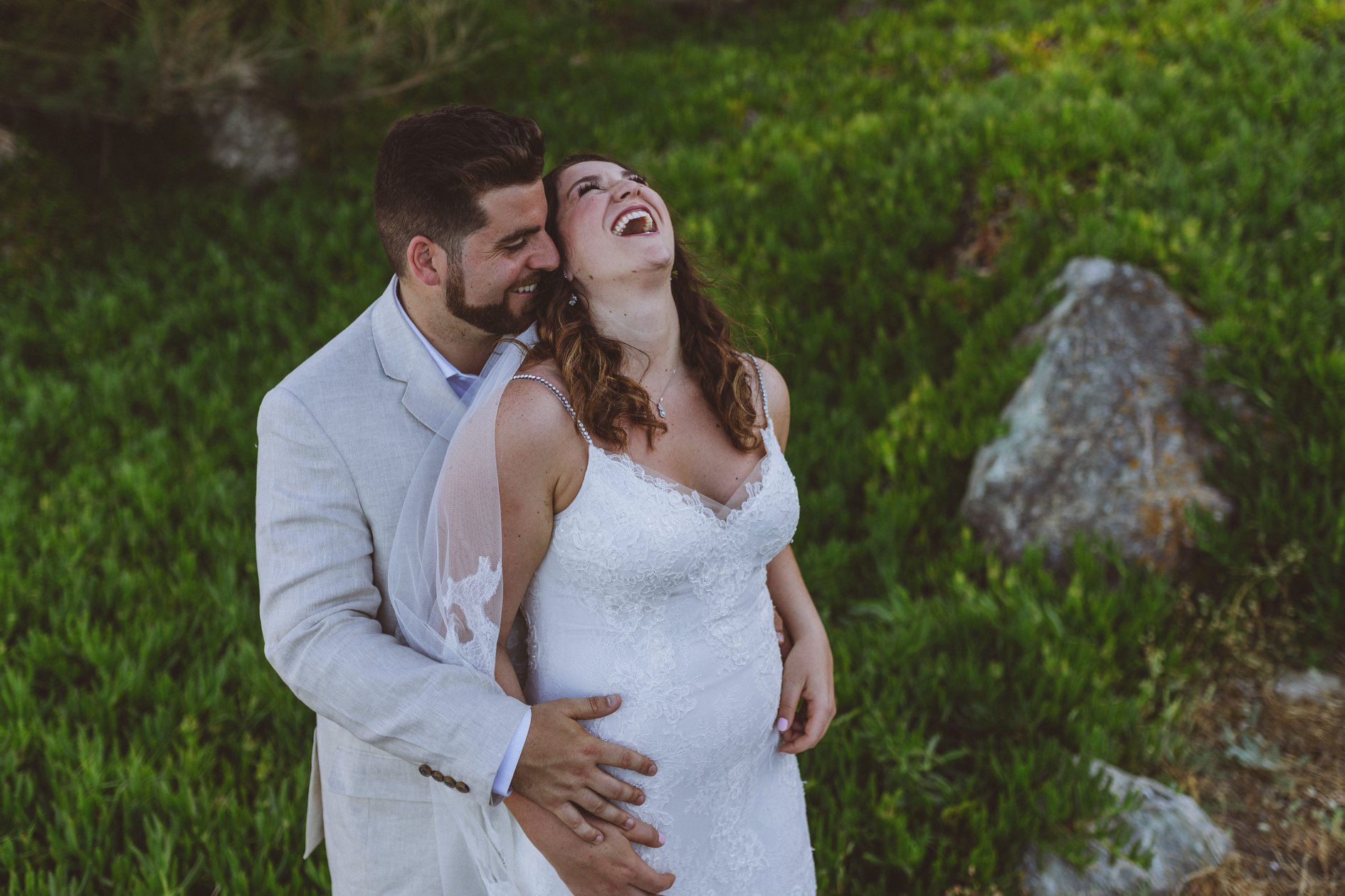 A bride and groom at their post ceremony photo shoot. They look very happy and in love.